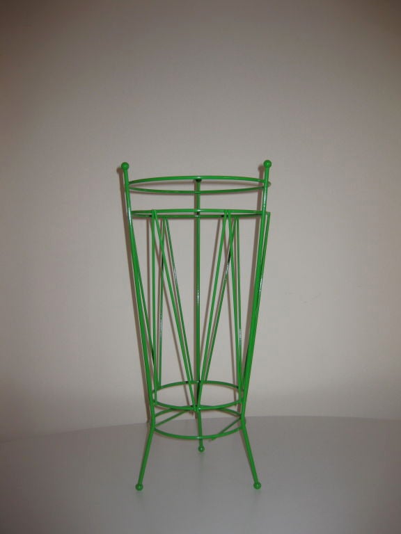 Keep your umbrellas in one spot with this fun green umbrella stand.  Perfect for storage inside the home, its bold, powder coated green and wire design is the ultimate functionality that is sure to impress.  Great accent for any foyer.<br />
<br