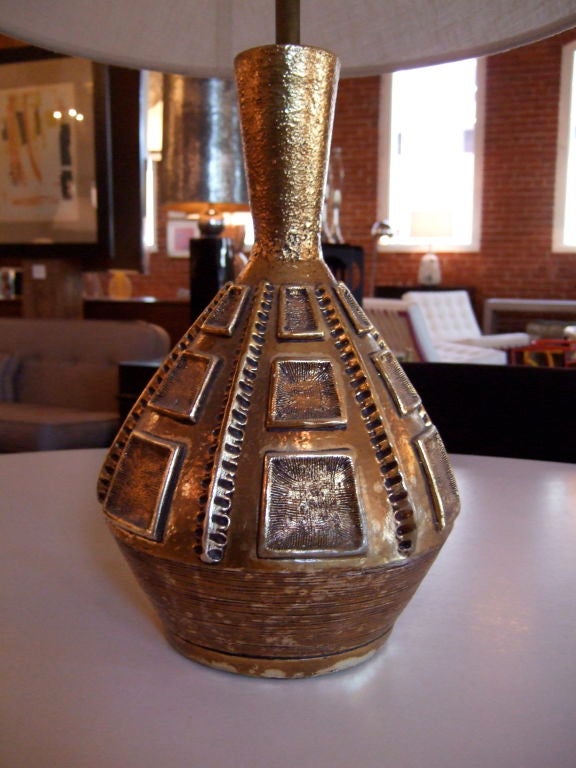 Fantastic gold toned ceramic lamp made by Fortune Lamp Co with excellent textures.  Taking design cues from sculpture and art history, this lamps has a striking, artful presence, sure to make an impact in any room.  Shade not included.<br />
<br
