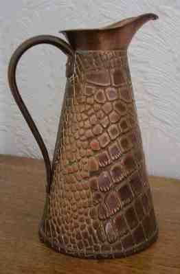 A Solid Copper Alligator Embossed Pitcher