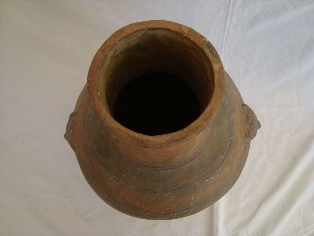 A large well formed early storage jar with excellent coloring and two intact rope handles. 

This jar would make an excellent lamp with a drop-in light. An estimate for one can be provided.