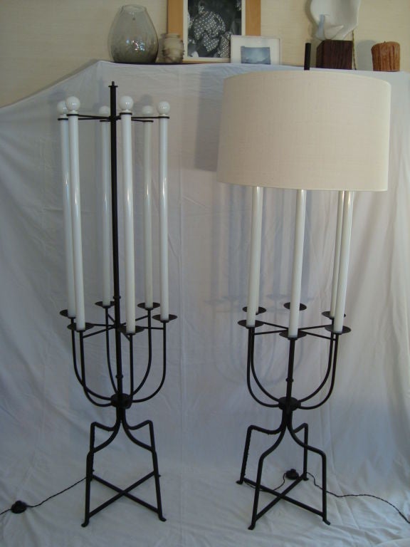 A large pair of well-crafted floor lamps by Tommi Parzinger with six lights each, reminiscent of Jacobean candlesticks.

Reference: For a nearly identical iron floor lamp with six lights by Tommi Parzinger, please see pg. 180 of 'Modern