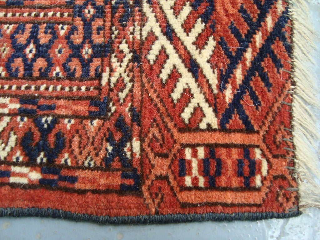 A hand-knotted throw rug with nice wear and a beautiful pattern. One of two that are similar.