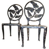 Vintage A Pair of Metal Chairs with a Banana Leaf Motif.