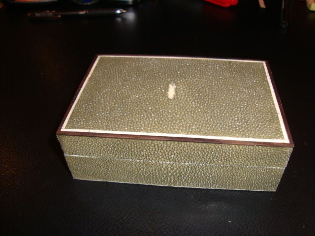 A fine small shagreen jewelry, card or cigar box with inlaid mother of pearl along the inside edge, and ivory on the outside edge.