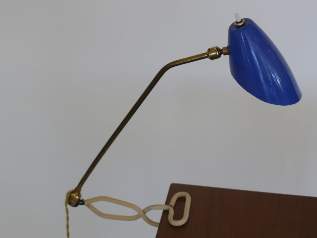 Articulating desk light with original royal blue metal shade that pivots.  Light clamps on to the side of desk or surface.  Professionally rewired.