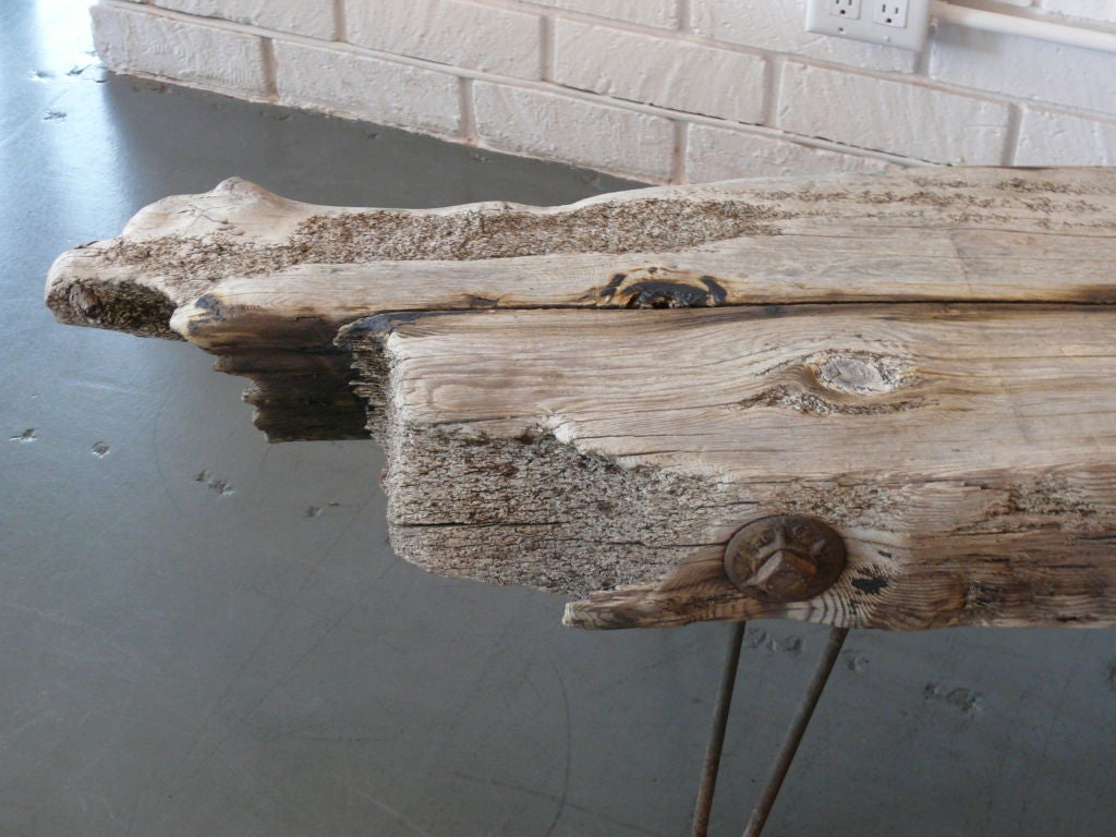One of a kind large slab of driftwood floating on iron hairpin legs.  Wonderful patina to wood and interesting addition to any room.
