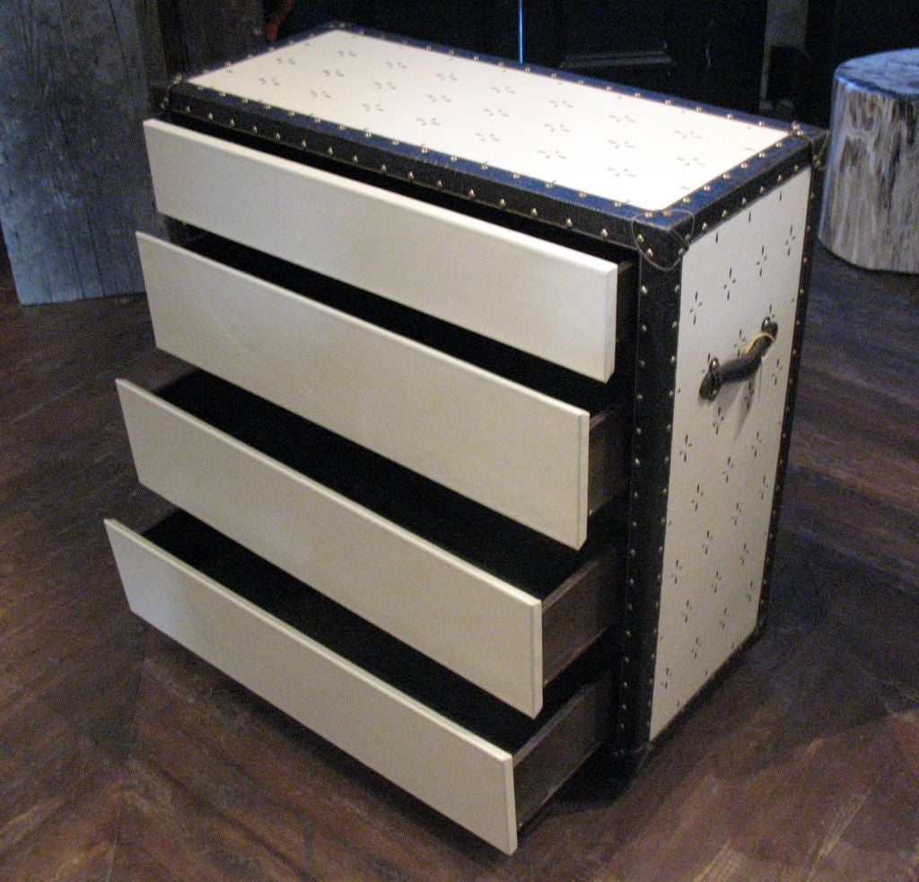 sumptuous, creamy, die cut leather with embossed faux croc. leather trim. small brass rivets finish this unique<br />
version of a 4 drawer dresser.<br />
<br />
price for each