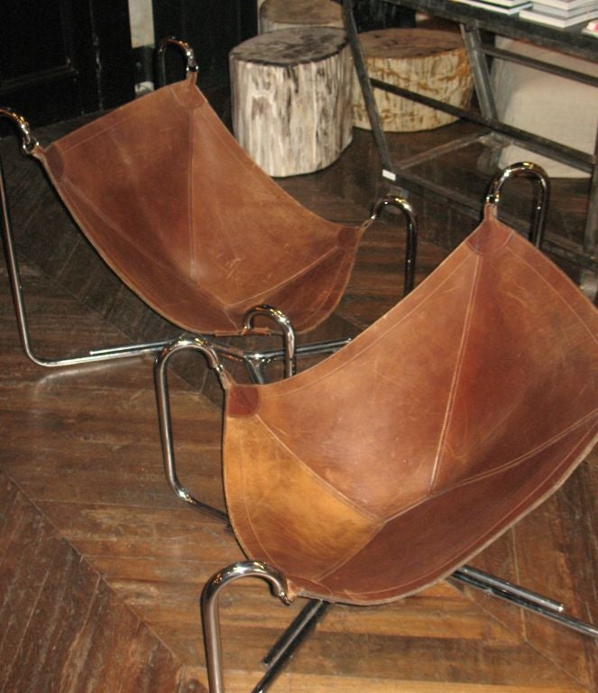 incredible, chrome and leather sling chairs. hand stitched<br />
with the leather patina that only comes with age.<br />
price is for pair