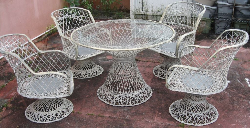 Superb late 60's Alumcraft spun aluminum outdoor patio set.  About as pristine as it gets, this set has it's original baked-on white/gray striated finish. All chairs rotate, two are also rockers, and can be used separately as such. Table is designed