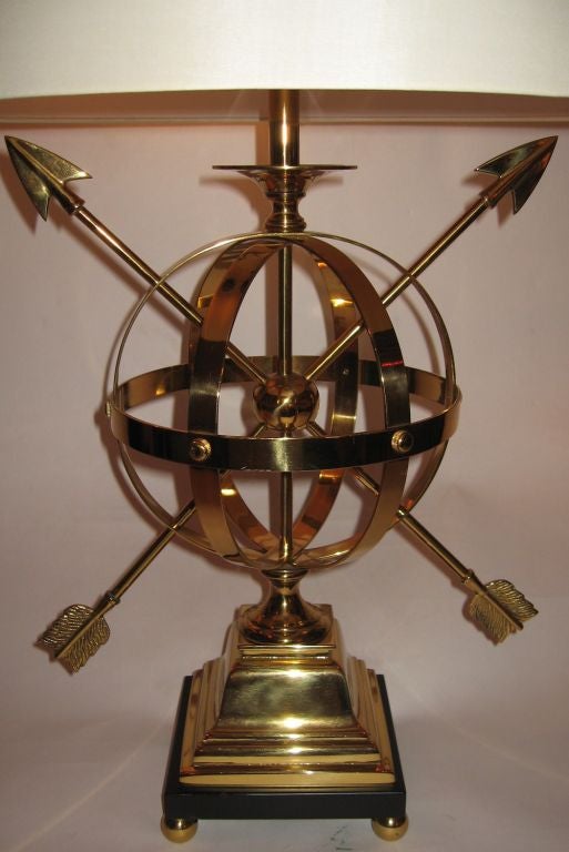 Beautiful pair of Frederick Cooper vintage brass armillary form table lamps dating to the early 1960's.  Rewired and refinished, this pair are raised on a black wooden base, and are well made examples done in solid brass. Shades are ecru silk over