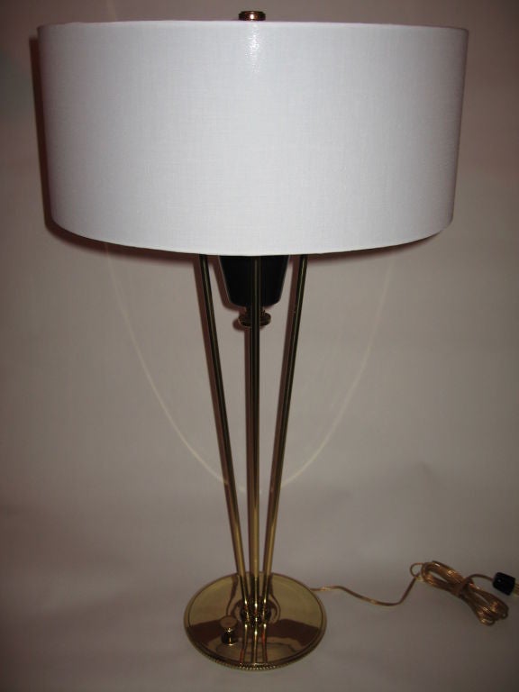 Very rare pair of fully reconditioned machine age style table lamps by Stiffel, dating to 1954.  Made of brass and oiled bronze finished steel, this pair retain their original brass reflectors, finials, and rare brass turn switches.  Shades have