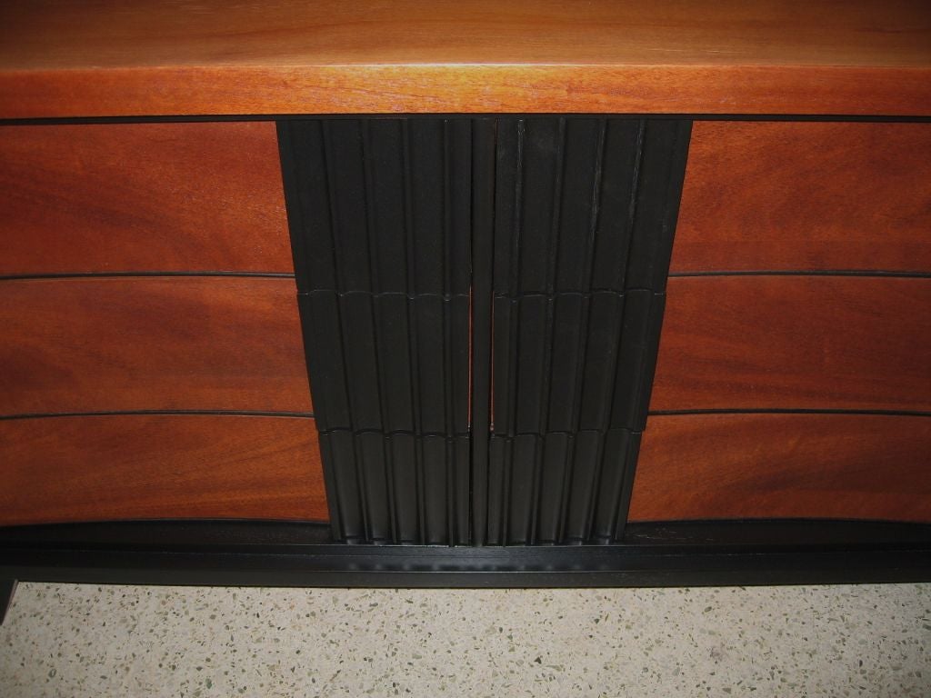 Fantastic mid century modern six drawer dresser or chest of drawers by Dixie Furniture, dating to the mid 1950's. Beautifully rendered in mahogany veneers and hardwood solids, this piece has been refinished in a warm medium brown and black ebonized