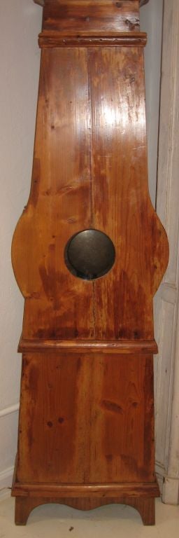 Lovely rusticated French country pine tall case clock dating to approximately 1750. Rough hewn planks, handmade iron pins latch sides and door panels together. Heavy hand poured iron weights. Clock was working when removed from home of most recent
