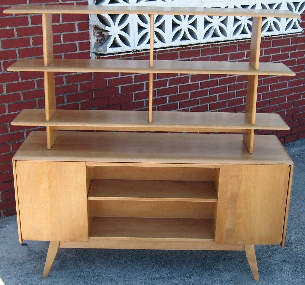 Superb and rarely found room divider by Heywood Wakefield, dating to the 1950's. Made of solid maple, this piece was designed as a true room divider, finished on both sides with shelving and cupboards. Slide out desk top can be accessed from both