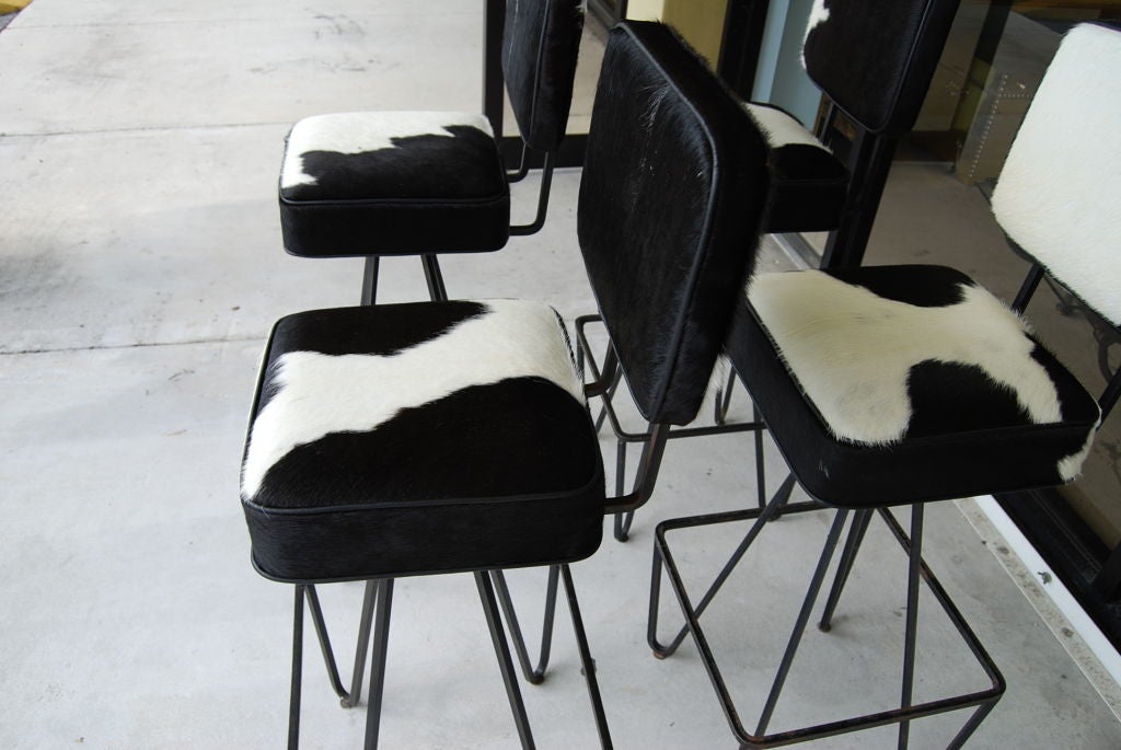 Set of  four 1950's Frederick Weinberg swivel barstools.Expertly upholstered in cowhide with leather welting.<br />
Seat 31