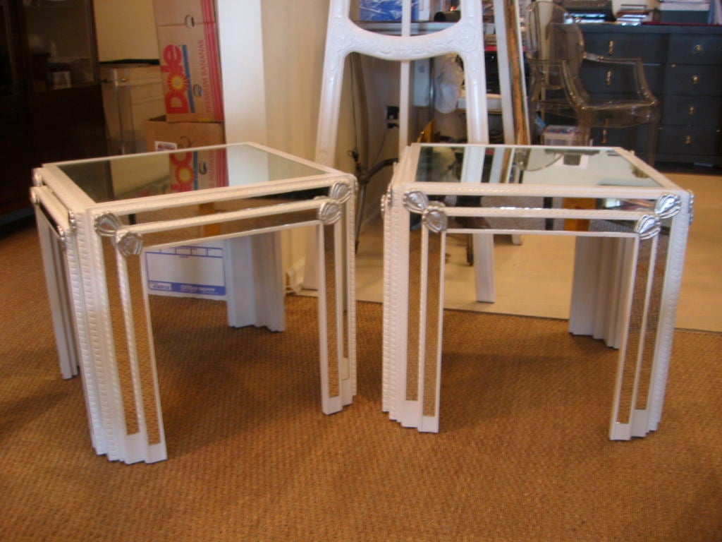 Pair of vintage end or side tables in high gloss white lacquer with braiding detail surrounding all four sides. Mirrored strips inset on all sides with 16 silver leaf medallion's throughout. Both have mirrored tops. Please inquire about our matching