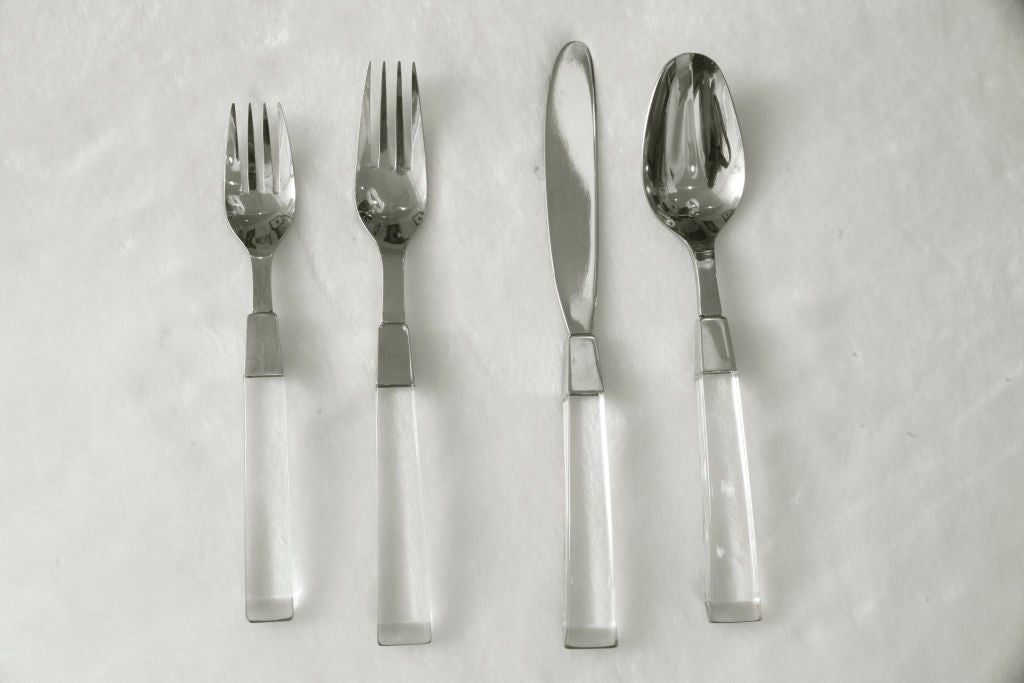 Wonderful flatware service with thick lucite handles and stainless steel bodies. Service is for eight people with a seven piece place setting per person consisting of 1 salad fork, 1 dinner fork, 1 dessert fork, 1 table spoon, 1 tea spoon, 1 dessert