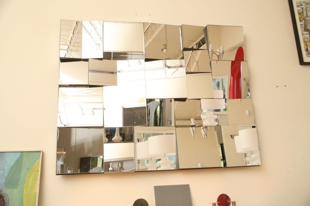 Original monumental multi faceted sculptural mirror by Neal Small. This is the large rendition of the originals that were designed in the 1970s--it is not a reproduction. An optical effect is created using many blocks of mirror of varying sizes on