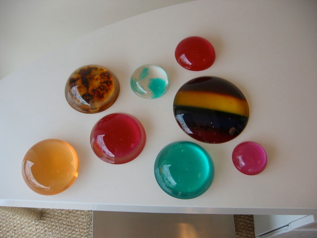 Luscious colors were used in making these wonderful resin paperweights or sculptures. They look fantastic on a glass surface as the colors change with the play of light. On a white surface they look like round glass tiles. They are fun where ever