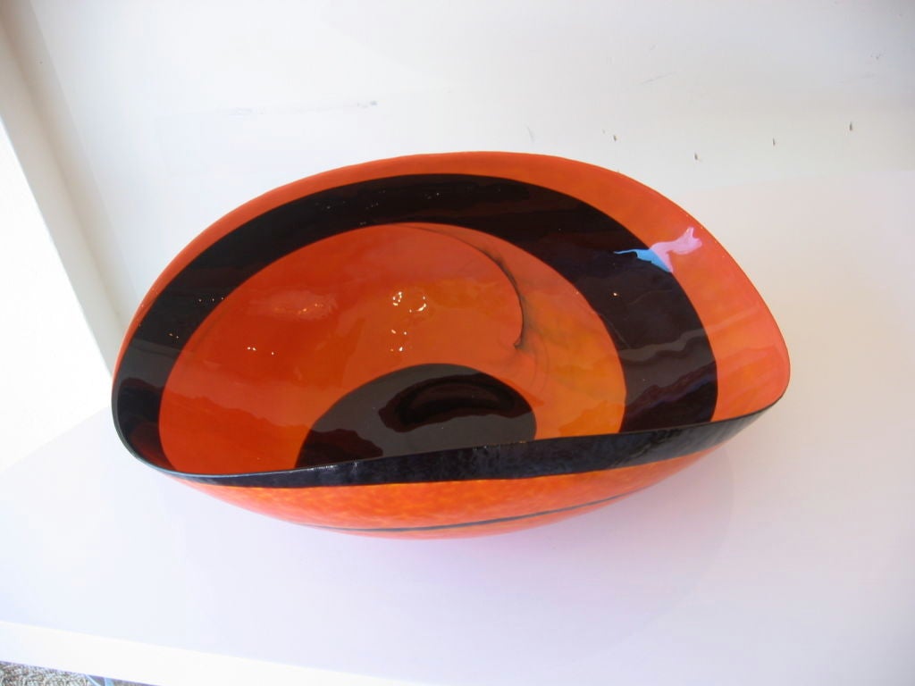 Fabulous murano glass centerpiece bowl on rich orange with black swirls. The design is taken from hand carved bowls from primitive nations, almost a scooped shape. Looks great with exotic fruits or as a great display piece.  Signed on the bottom