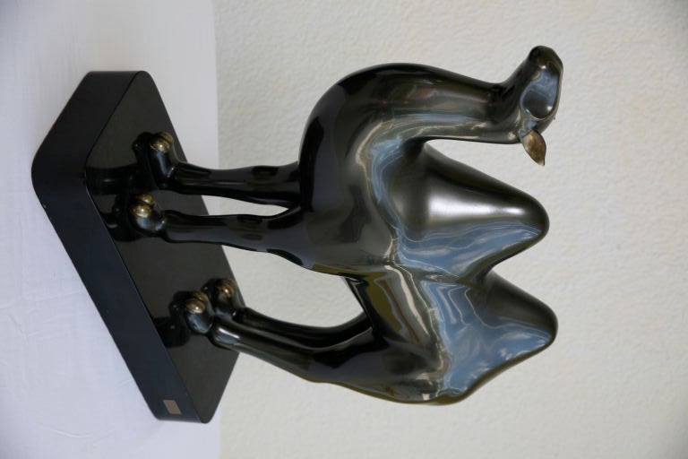 Camel sculpture done in bronze with an enamel coating. The tail and ears are brass. Signed on a metal plate. This sculpture is from the Casa Bella Showroom. Roberto Estevez designed jewelry for Cartier, Van Cleef and Arpels and was also represented