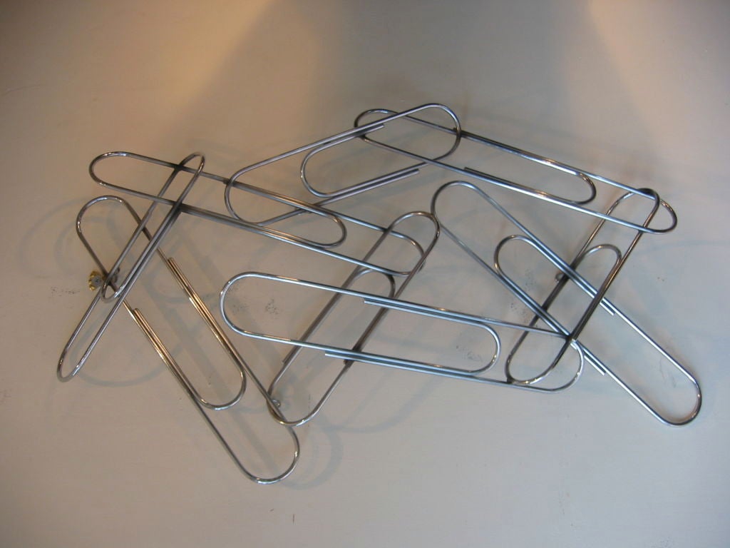 Fantastic wall or table top chrome sculpture comprised of nine giant paper clips randomly placed and welded together. A great whimsical and fun piece of art. Can be horizontal or vertical.