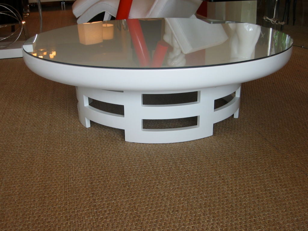 High gloss white lacquer round table. Open work fencing base with larger round top. Custom fitted round glass top. Designed by Theodore Muller and Isabel Barringer for Kittinger.