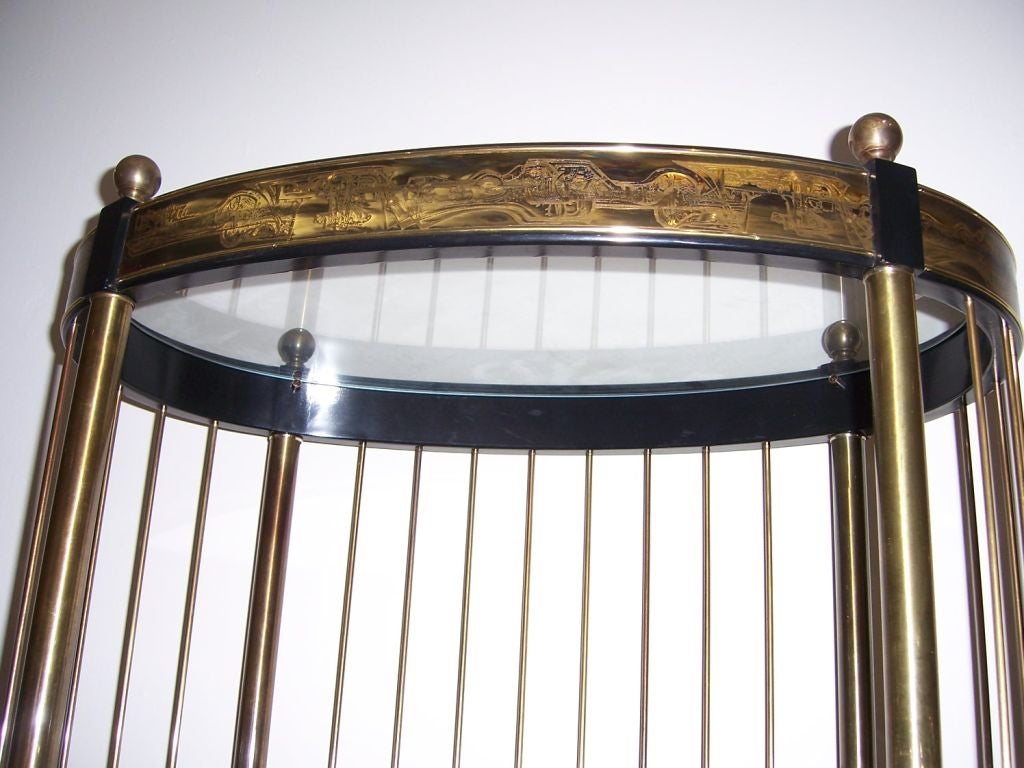 Fantastic five-tier oval shaped etagere with acid edge bronzed and ebonized wood.