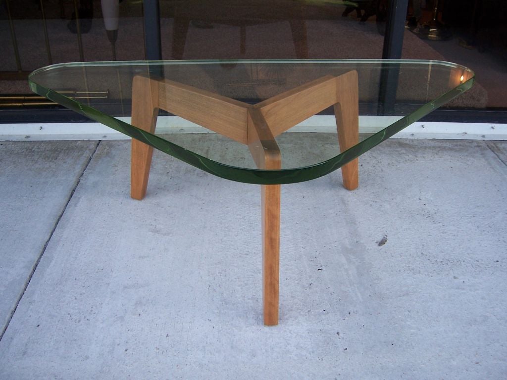 this is a tripod base table made of Italian Walnut and impeccable 1 1/2 inch thick green glass. Style of Fontana Arte
