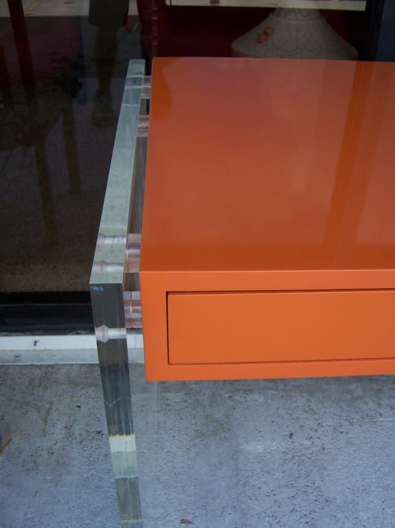 Wood An Hermes Orange Lacquered Desk with Lucite