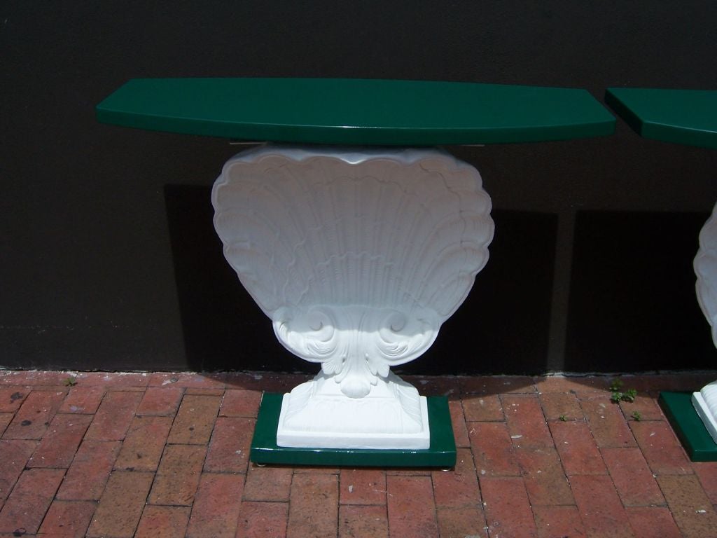 Fantastic pair of plaster Venus shell consoles in beautiful green lacquer.  These are in pristine restored condition - one is slightly taller than the other but we have installed risers to create matching heights (not noticeable).

This item is