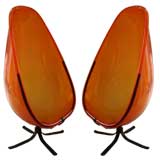 A Pair of Orange Lucite Cocoon Swivel Chairs