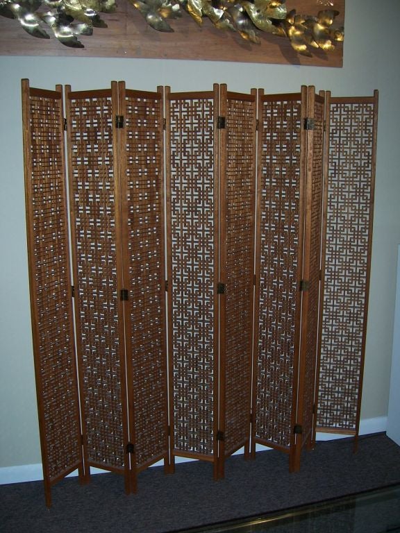 Amazingly intricate lattice work on this eight-panel room divider.  Stands on low rise feet on base.