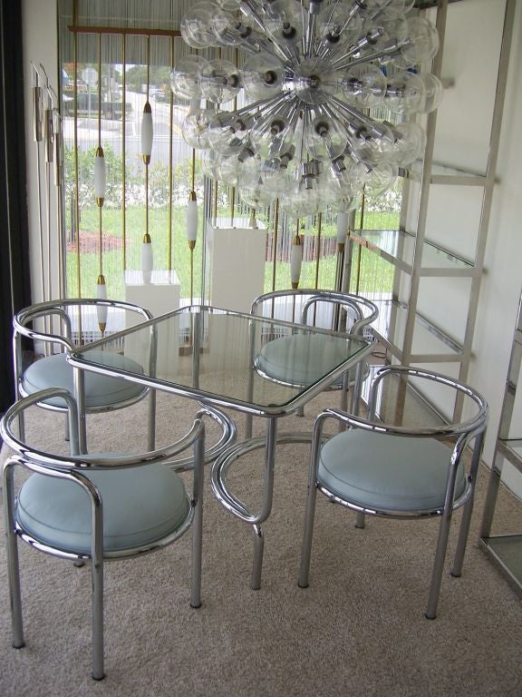This Postmodern bent tubular chromed game table and set of four chairs can also be used as a small dining table. Italian chic, classic Gae Aulenti design!   Dimensions of chairs: 26