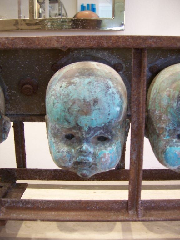 Beautiful patina on these baby doll heads sourced from a factory producing these in 1930's.  Perfect to sit on a shelf or as a wall sculpture.
