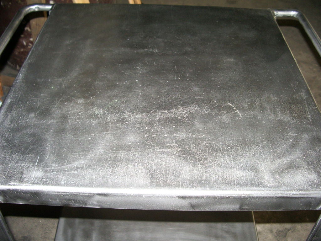 Polished industrial metal cart on wheels