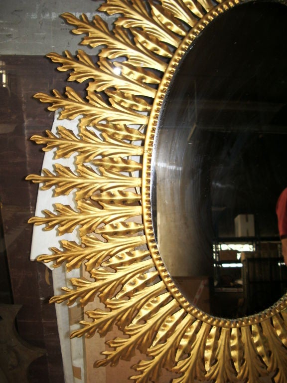 Metal oval frame double leaf mirror in gold color.Nice old patina. Mirror size is 23 1/2