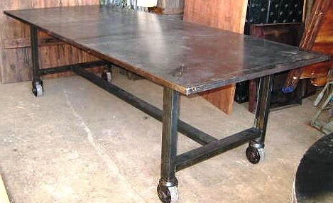 Industrial dining table made of iron. The frame is on mini wheels for easy transportation.