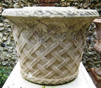 Great pair of stone planters with a basket weave design.<br />
Nice wide opening. Parts of the urns are covered in moss.