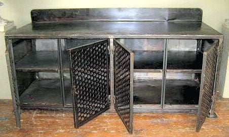 This iron cabinet has four doors and ample room for storage. It would make a great cabinet for a tv and stereo system. There is a center shelf. The doors have an open mesh design. The back height measures 37.5