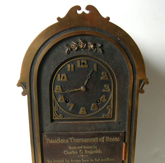 This fabulous winding clock was a presentation to the Tournament of Roses committee in 1914, commemorating 25 years of the Pasadena event. The bronze work and verse were created by Charles C. Reynolds. The solid bronze case was executed in the Arts