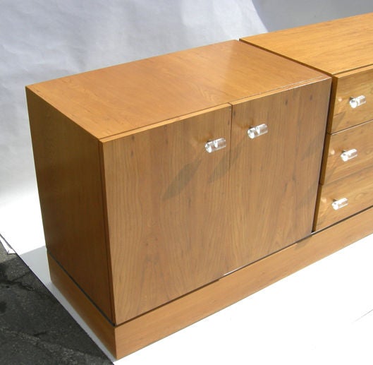 Classic clean lines dominate this 1970's Baughman design. The cabinet is executed in finished ash wood, accented with chrome bands and lucite pulls. The condition is excellent, and retains the original label in the top drawer. The cabinet could be