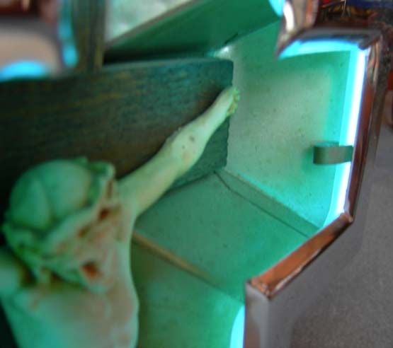 Create your own home shrine with this lovely sculptural cross. Encased in chrome, the Lord lights up in cool blue neon with a twist of the switch. The neon transformer is built into the base of the cross, and only needs to plug into a standard