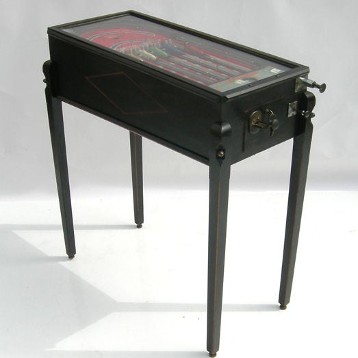 These lovely petite table games actually pre-date the pinball game that we all are more aware of. The game is non electric, and easy to place anywhere with its diminuitive size. The concept is simple- rotating players get a shot and shooting a ball