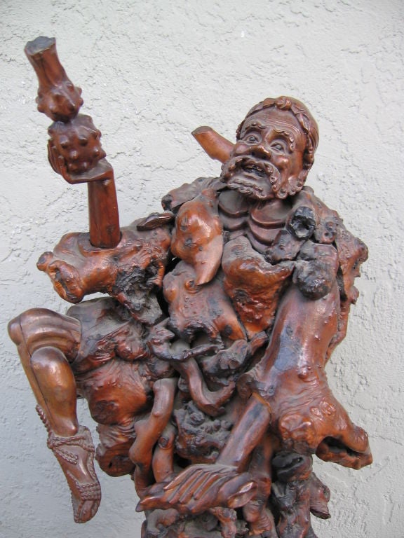 Very rare and elaborate root sculpture. The main subject, a bearded man with a staff, is removable from the root. The two scholars on his sides are also removable from the supporting root.<br />
Very fine carving.
