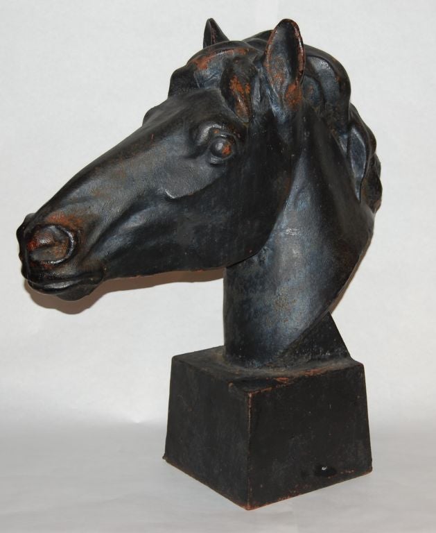 Cast Iron Horsehead<br />
U.S.<br />
Early 20th Century<br />
stylish and articulated cast horse head<br />
the blocky, masculine casting offset by the delicate details and wonderful patina<br />
like knights from a giant chess set