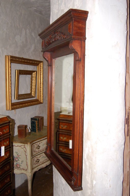 Late 19th century oak mirror with carved wood garland and original mirror. Measures: 29.5'' W x 42.5'' H x 1'' D.