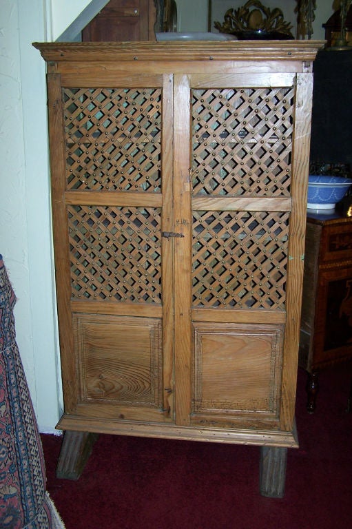 A late 18th-early 19th century lattice front pine cabinet or roper with three shelves. In beautiful original condition with remnants of old paint on the inside.