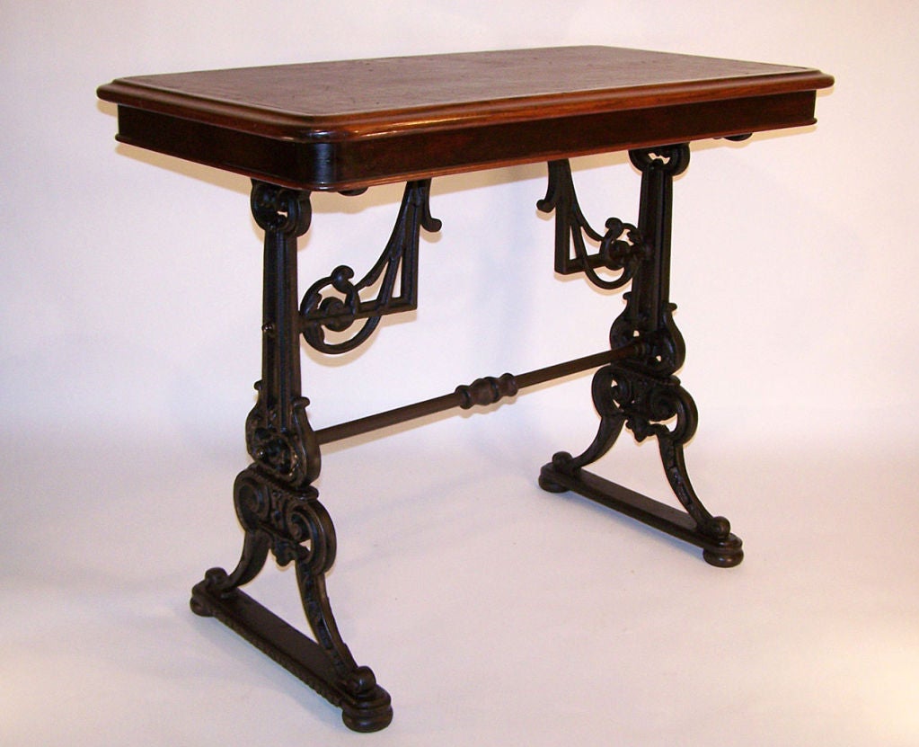 Great looking table! Cast iron base with wood top and leather inset.