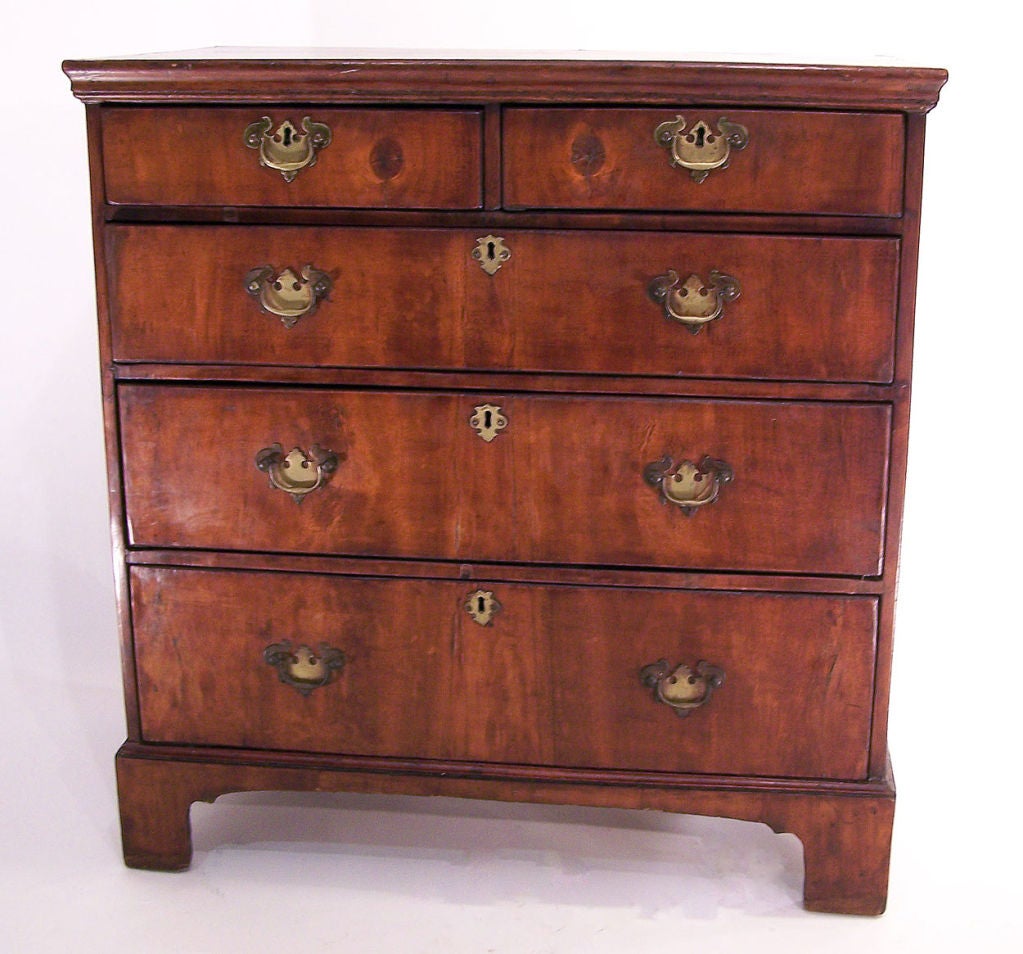Beautiful walnut veneers on oak and highly figural walnut top with feather banding. Mid-late 18th century hardware. Very old if not original finish. Excellent color and look. English, circa 1760.